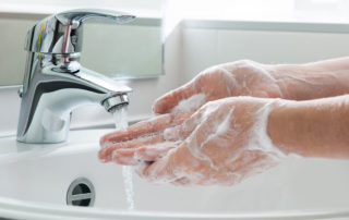 washing hands with soap in sink