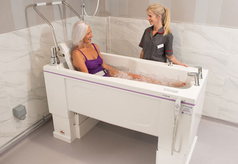 Woman in bath with carer