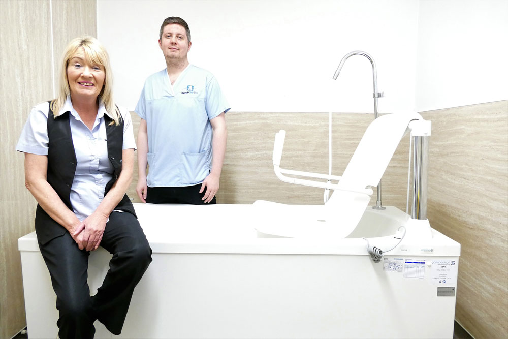 staff-sat-on-gentona-bath staff at Balhouise care home sat on bath